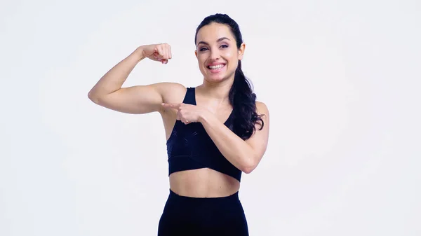 Smiling Sportswoman Pointing Muscle Isolated White — Stock Photo, Image