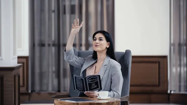 Happy Businesswoman Holding Menu Gesturing Lobby Restaurant — Foto Stock