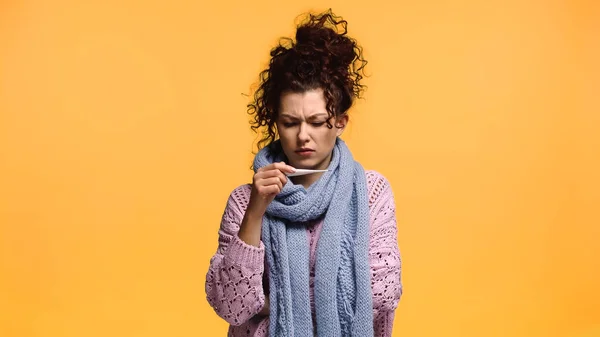 Displeased Woman Knitted Sweater Scarf Looking Thermometer Isolated Orange — Stock Photo, Image