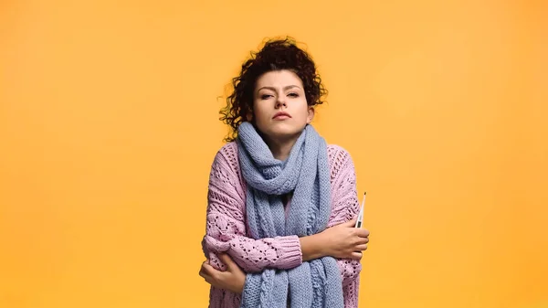 Ill Woman Hugging Herself While Holding Thermometer Isolated Orange — Stock Photo, Image