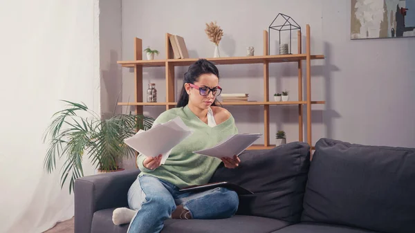 Confused Student Eyeglasses Looking Documents Couch — Stock Photo, Image