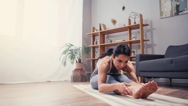 Deportiva Enfocada Estirándose Casa — Foto de Stock