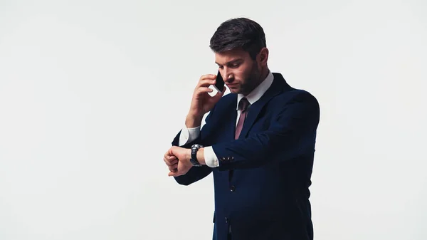 Manager Suit Looking Wristwatch While Talking Smartphone Isolated White — Stock Photo, Image