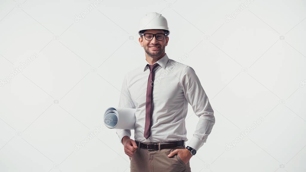 Smiling engineer with blueprint looking at camera isolated on white