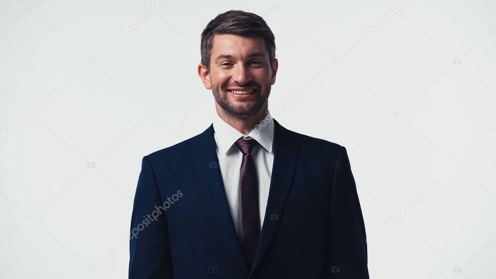 Smiling businessman in formal wear looking at camera isolated on white