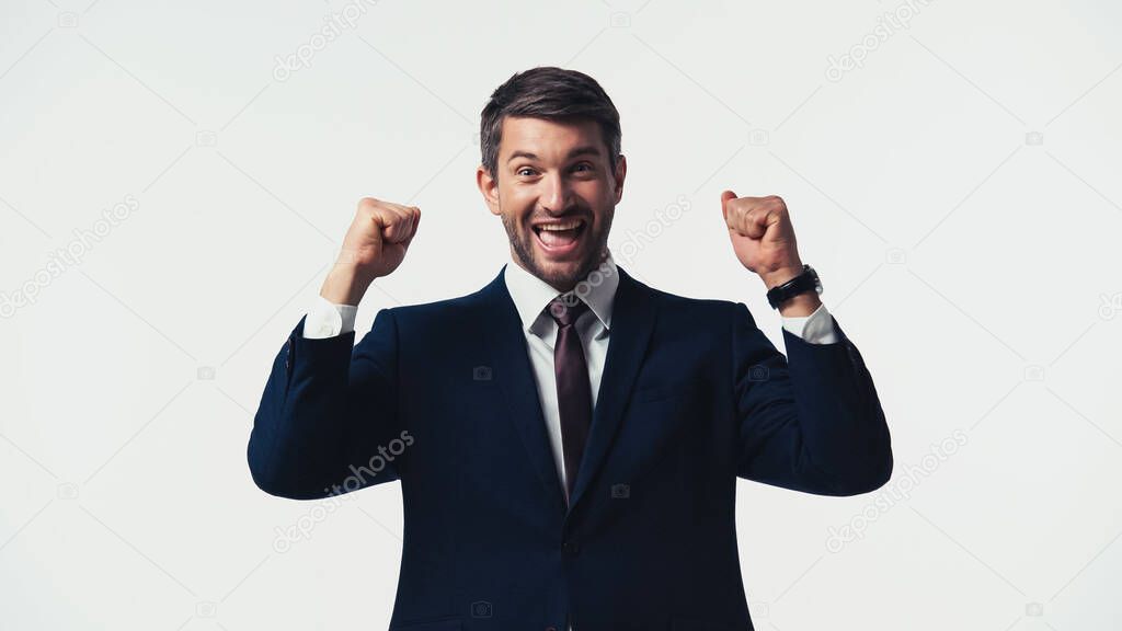Excited manager in suit showing yes gesture isolated on white