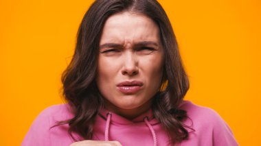shocked and disgusted woman grimacing isolated on yellow clipart