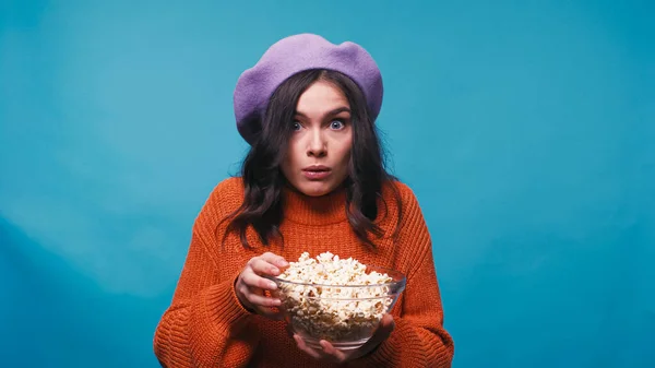 Thrilled Woman Holding Bowl Popcorn While Watching Film Isolated Blue — Stock Photo, Image