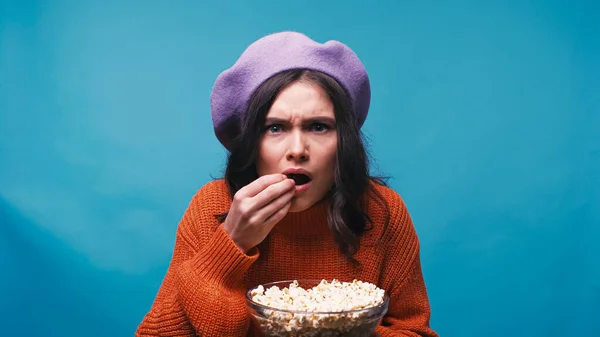 Nervous Woman Eating Popcorn While Watching Exciting Film Isolated Blue — Stock Photo, Image