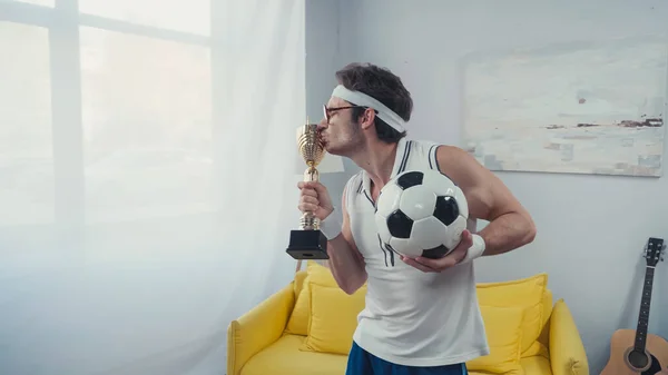 Football Player Kissing Golden Trophy Cup Holding Soccer Ball — Stock Photo, Image