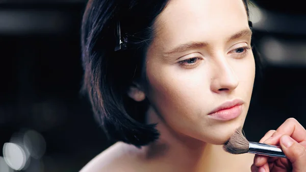 Make-up-Artist Anwendung Make-up Foundation mit kosmetischen Pinsel auf das Gesicht des hübschen Modells — Stockfoto