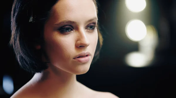 Pretty and brunette model with makeup looking away — Stock Photo