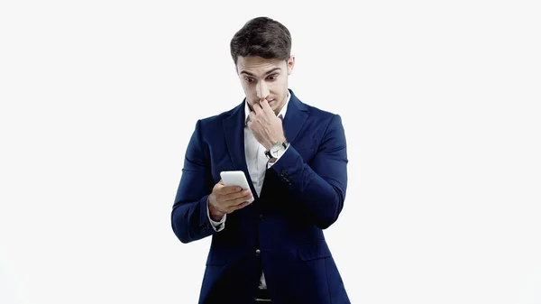 Empresário surpreso olhando para smartphone isolado em branco — Fotografia de Stock