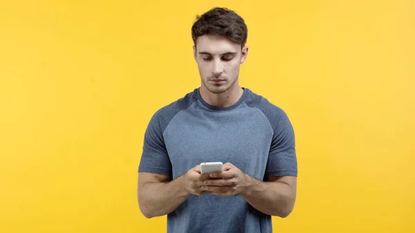 Hombre morena usando teléfono inteligente aislado en amarillo - foto de stock