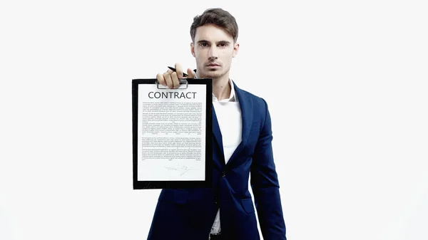 Young businessman holding pen and contract on clipboard isolated on white — Stock Photo