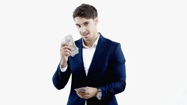 Smiling businessman looking at camera and holding dollars isolated on white — Stock Photo