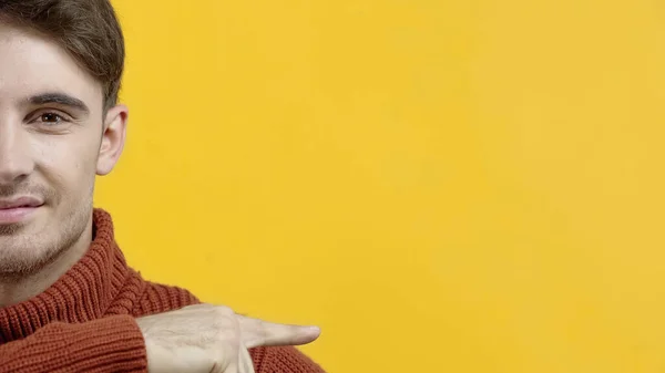 Cropped view of smiling man pointing with finger isolated on yellow — Stock Photo