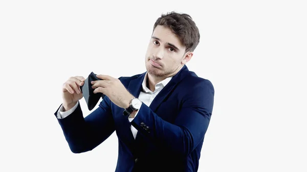 Confused businessman looking at camera while holding empty wallet isolated on white — Stock Photo