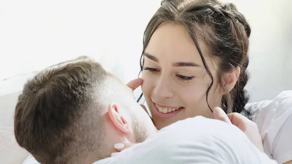 Счастливая брюнетка женщина трогает лицо бойфренда дома — стоковое фото