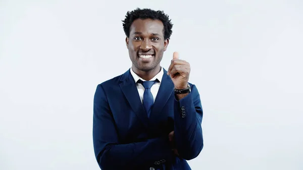 Pleased african american businessman in formal wear showing thumb up isolated on blue — Stock Photo