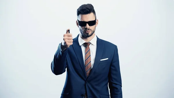 Confident businessman with pen and dark sunglasses isolated on white — Stock Photo