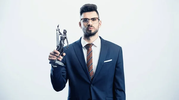 Confident businessman with justice statuette looking at camera isolated on white — Stock Photo