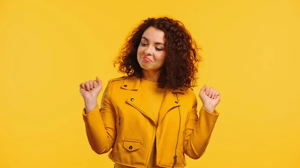 Proud young woman in leather jacket isolated on yellow — Stock Photo