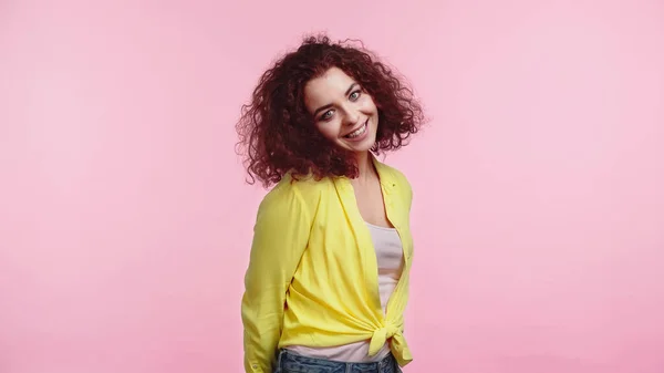 Cheerful young woman in yellow shirt isolated on pink — Stock Photo