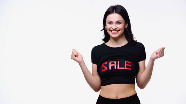 Pretty woman in top with sale lettering showing yes gesture isolated on white — Stock Photo