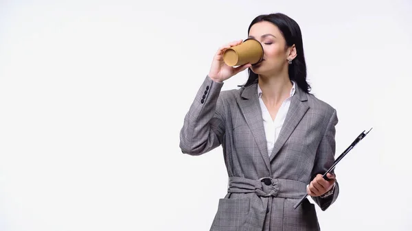 Businesswoman with clipboard drinking coffee to go isolated on white — Stock Photo