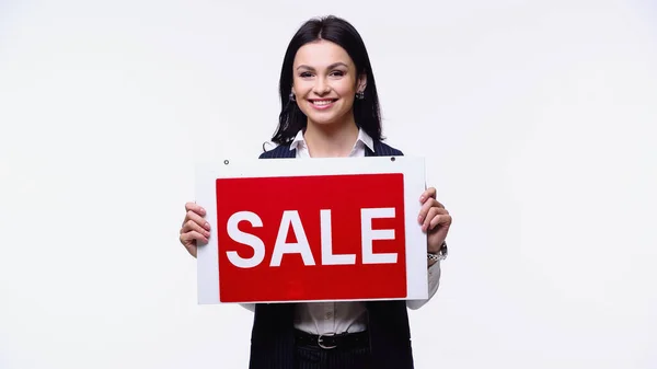 Smiling agent holding signboard with sale lettering isolated on white — Stock Photo