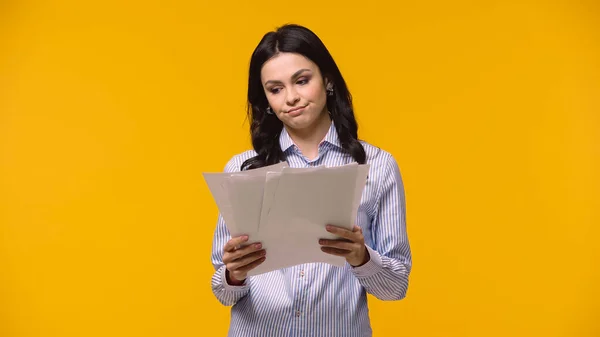 Tired manager looking at papers isolated on yellow — Stock Photo