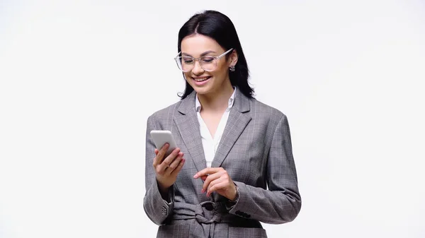 Mujer de negocios sonriente en gafas con teléfono inteligente aislado en blanco - foto de stock