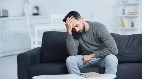 Homme stressé regardant dossier et toucher la tête à la maison — Photo de stock