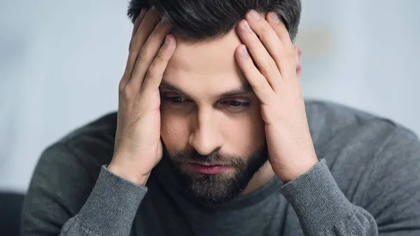 Dissatisfied and bearded man touching forehead with hands — Stock Photo