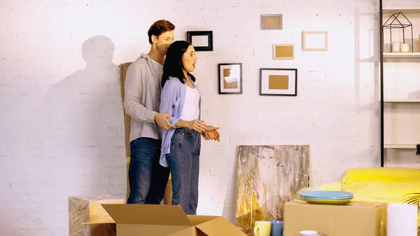 Shocked woman looking at new home near boyfriend — Stock Photo