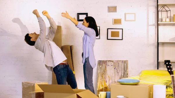 Excited couple rejoicing in new home — Stock Photo