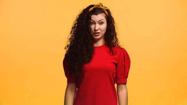 Displeased woman feeling aversion while looking at camera isolated on orange — Stock Photo