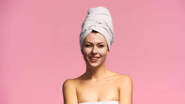 Joyful woman with peeling mask on face looking at camera isolated on pink — Stock Photo