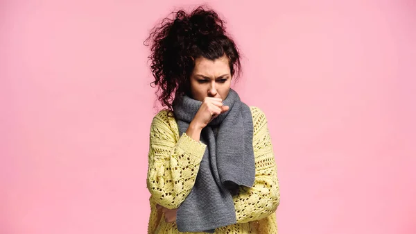 Diseased woman in knitted sweater and scarf coughing isolated on pink — Stock Photo