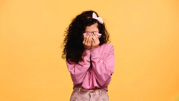 Depressed woman covering face with handkerchief while crying isolated on orange — Stock Photo