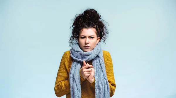 Frozen woman with clenched hands looking at camera isolated on blue — Stock Photo