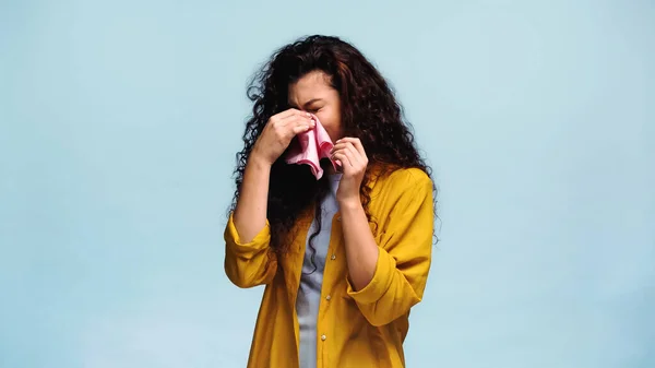 Mujer molesta limpiando los ojos con el pañuelo mientras llora aislado en azul - foto de stock