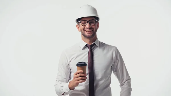 Positive architect with paper cup looking at camera isolated on white — Stock Photo