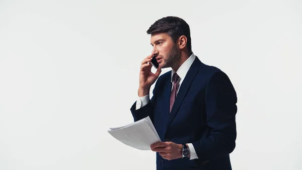 Side view of businessman with papers talking on cellphone isolated on white — Stock Photo