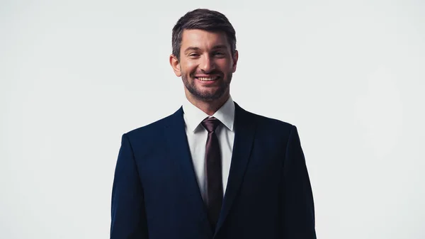 Smiling businessman in formal wear looking at camera isolated on white — Stock Photo