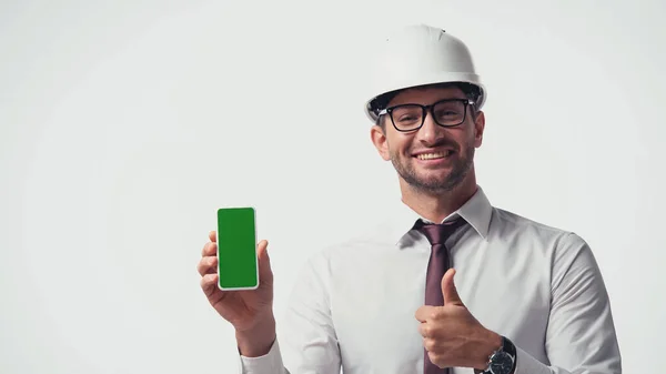 Engineer showing smartphone with chroma key and like isolated on white — Stock Photo