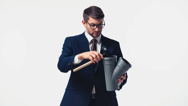 Businessman in suit holding pipe and plunger isolated on white — Stock Photo