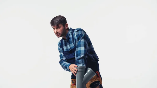 Plumber in uniform holding plastic pipe isolated on white — Stock Photo