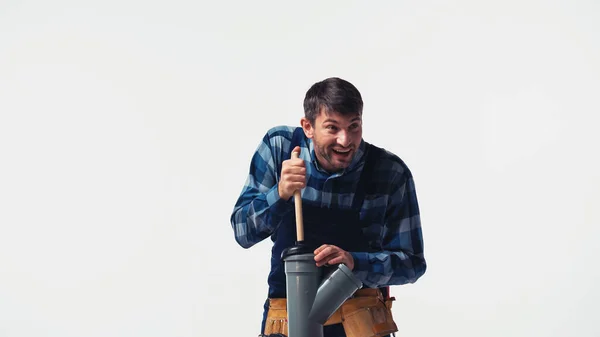 Smiling workman with plunger and plastic pipe isolated on white — Stock Photo